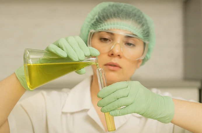 Laboratory operator measuring refined fish oil parameters for oxidation control and quality assurance.