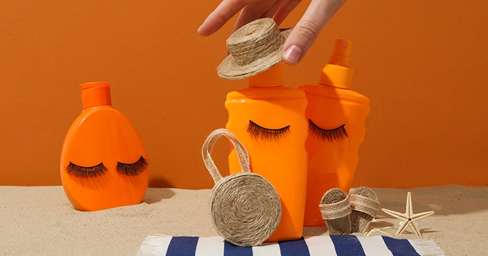 Creative sunscreen packaging with summer accessories on a beach-inspired background