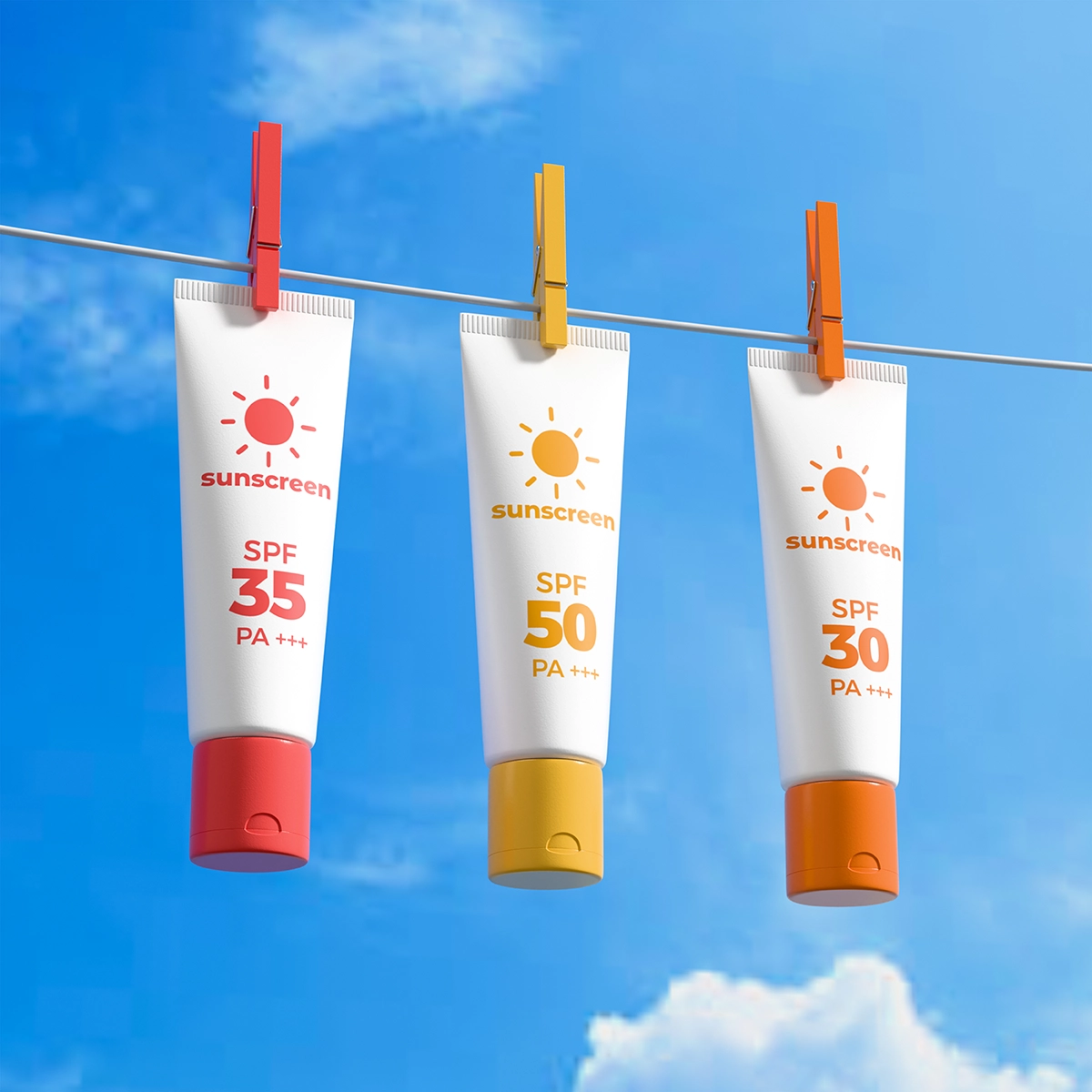 Three sunscreen tubes with different SPF levels hanging on a clothesline against a blue sky